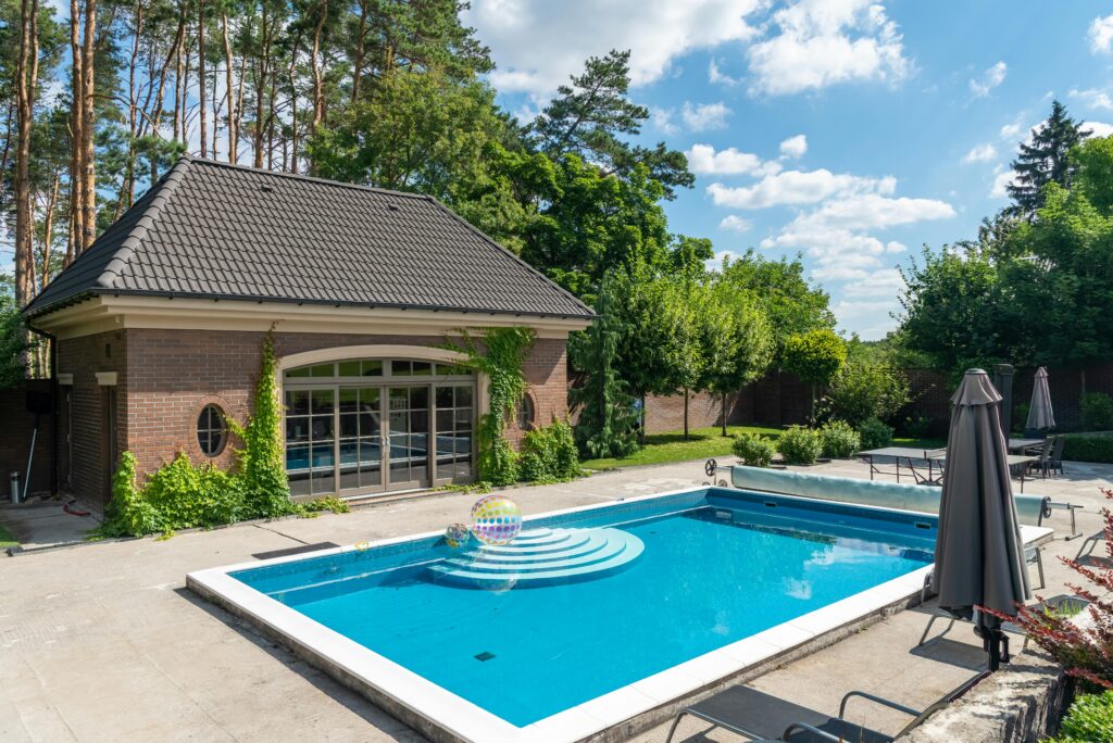 Elegant poolside setup with a modern patio, ideal for summer relaxation.
